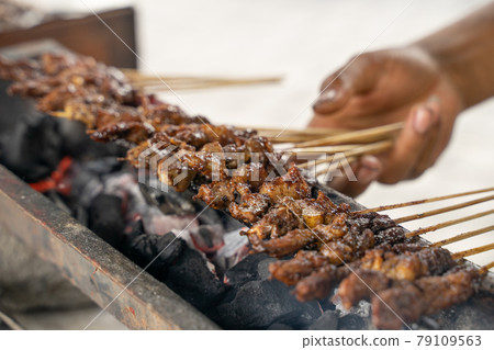 sate ayam traditional culinary of chiken satay skewer being grilled using charcoal sate ayam traditional culinary of chiken satay skewer being grilled using charcoal 79109563
