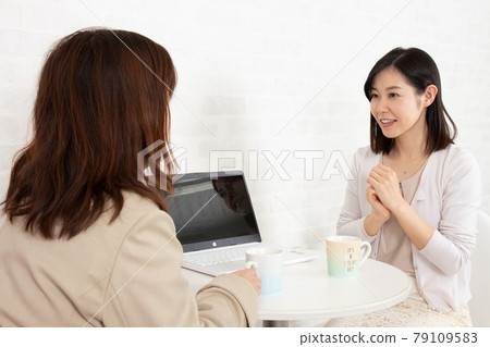 Young girls consulting indoors (dating agency / marriage activity image) 79109583