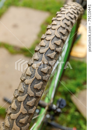Bike waiting mechanic for repair in bicycle repair shop, outdoor. Bicycle wheel close up ready for examines, fixes modern cycle transmission system. Bike maintenance, sport shop concept. Bike waiting mechanic for repair in bicycle repair shop, outdoor. Bicycle wheel close up ready for examines, fixes modern cycle transmission system. Bike maintenance, sport shop concept. 79110441