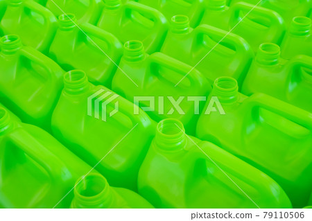 Many empty green plastic jerrycans background - close up 79110506