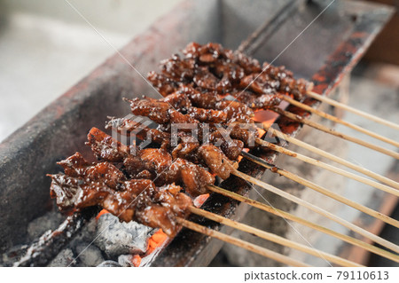 sate ayam traditional culinary of chiken satay skewer being grilled using charcoal sate ayam traditional culinary of chiken satay skewer being grilled using charcoal 79110613