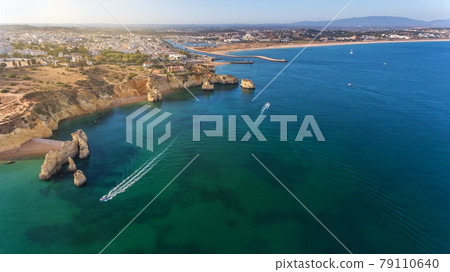 Aerial view of the beautiful paradise beaches of Camilo and Dona Anna, Lagos area. Tourist boats and ships entertain tourists on summer vacations. Aerial view of the beautiful paradise beaches of Camilo and Dona Anna, Lagos area. Tourist boats and ships entertain tourists on summer vacations. 79110640
