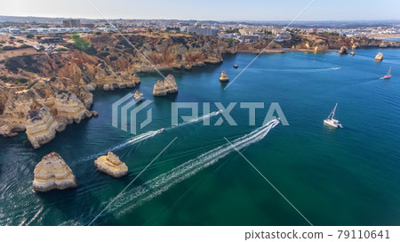 Aerial view of the beautiful paradise beaches of Camilo and Dona Anna, Lagos area. Tourist boats and ships entertain tourists on summer vacations. Aerial view of the beautiful paradise beaches of Camilo and Dona Anna, Lagos area. Tourist boats and ships entertain tourists on summer vacations. 79110641