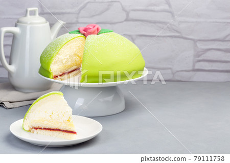Traditional Swedish dessert Princess cake with green marzipan cover and pink rose decoration, on  gray background, horizontal, copy space 79111758