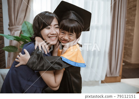 proud asian mother embrace her daughter during elementary school graduation day proud asian mother embrace her daughter during elementary school graduation day 79112151