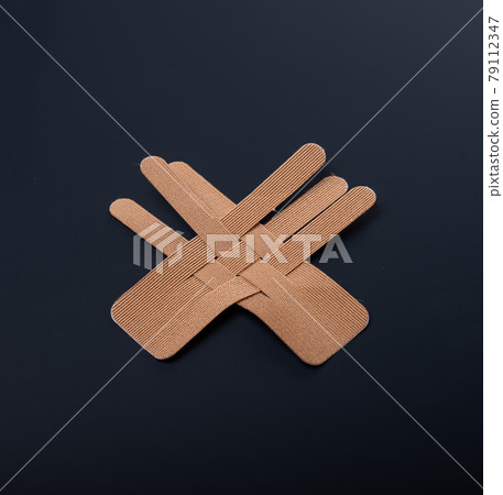 Tapes for face beautifully lie on a black background. Kineziotape for rejuvenation. tape to help fight wrinkles. Surgical rejuvenation. 79112347