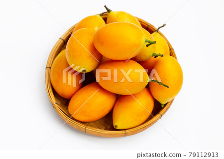 Marian plum fruit in bamboo basket on white background. 79112913