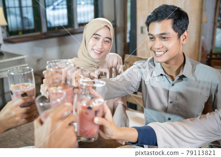 a man and woman celebrate and raise glasses of fruit ice for toast while breaking the fast together 79113821