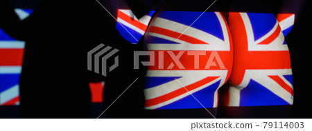 The projection of the flag of the United kingdon on a beautiful large female ass. The projector shines with a flag of the England on a female body. British  79114003