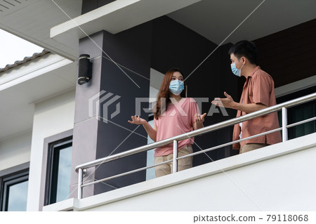 stressed couple wearing a face mask and quarantine in balcony of home, coronavirus (covid-19) pandemic concept 79118068