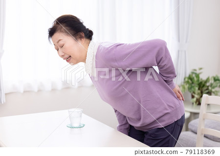 Senior women suffering from low back pain 79118369