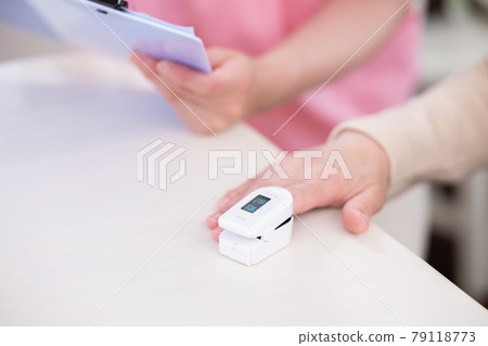 護理：用脈搏血氧儀測量氧濃度的老年婦女的手 79118773