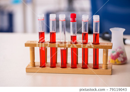 Tubes and pills on the desk in drugs synthesis concept Tubes and pills on the desk in drugs synthesis concept 79119043