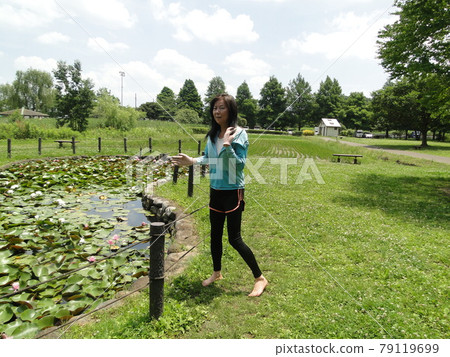 Healthy tall woman walking in the meadow Healthy tall woman walking in the meadow 79119699