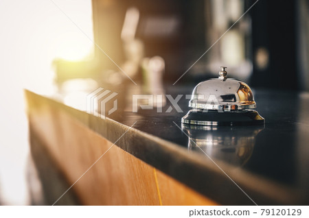 A front desk bell on reception counter. Hotel bell is normally use to call staff service and staff can help guests with any queries that they may have. A front desk bell on reception counter. Hotel bell is normally use to call staff service and staff can help guests with any queries that they may have. 79120129