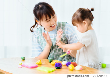 Girls and nursery teachers playing with toys 79120485