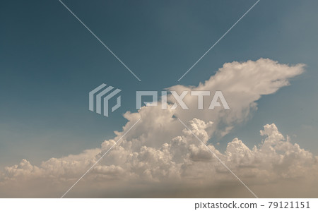 The sun shines through the clouds in the sky.  The shape of the clouds evokes imagination and creativity. 79121151