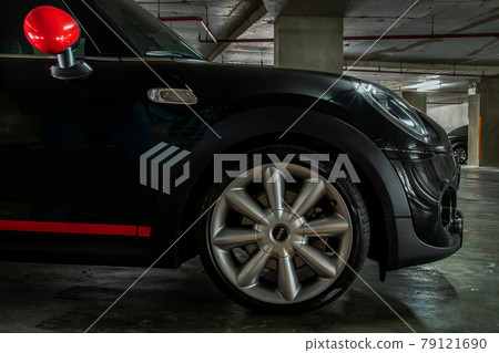 Side view of Headlights, Wheel, Hood, Sidelights and Side view mirror of Black car. Side view of Headlights, Wheel, Hood, Sidelights and Side view mirror of Black car. 79121690