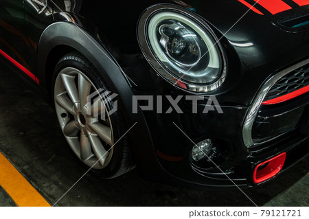 Close-up of Headlights, Wheel, and Rim of black car. Close-up of Headlights, Wheel, and Rim of black car. 79121721