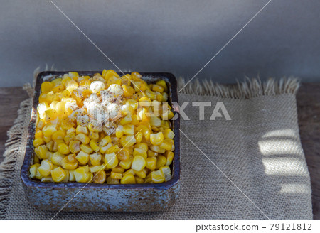 Fried sweet corn with a knob of butter and seasonings Sprinkle with ground black pepper in ceramic bowl and spoon. Fried sweet corn with a knob of butter and seasonings Sprinkle with ground black pepper in ceramic bowl and spoon. 79121812