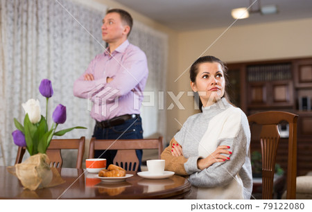 Man and woman are offended at each other because of the misunderstanding in his home Man and woman are offended at each other because of the misunderstanding in his home 79122080