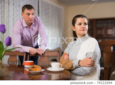 Annoyed husband and wife quarreling 79122094