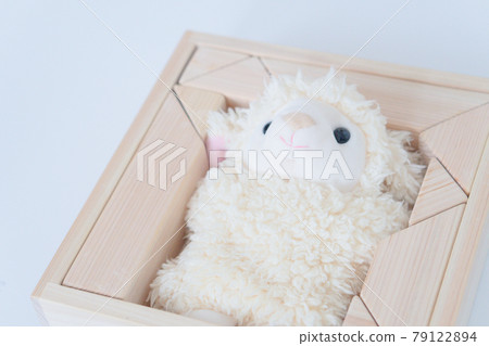 Stuffed sheep surrounded by building blocks Stuffed sheep surrounded by building blocks 79122894