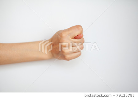 Female hand shows fig gesture, isolated on white background.  79123795