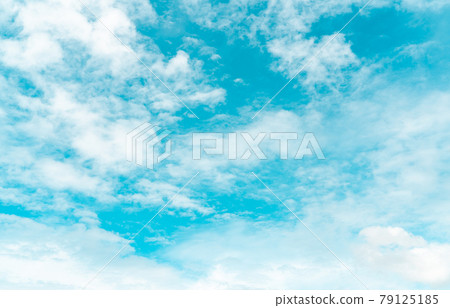 White fluffy clouds on blue sky. Soft touch feeling like cotton. White puffy cloudscape. Beauty in nature. Close-up white altocumulus clouds texture background. Sky on a sunny day. Pure white clouds. 79125185