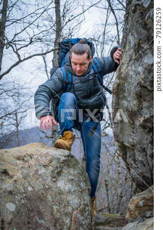 Tourist on the peak of high rocks. Sport and active life concept 79126259
