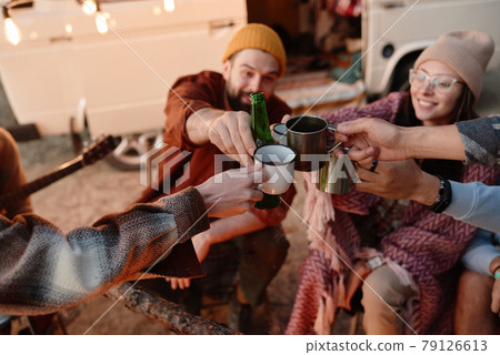 Friends toasting outdoors 79126613