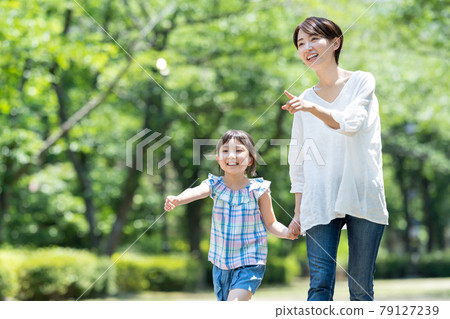 Happy parents and children walking hand in hand 79127239