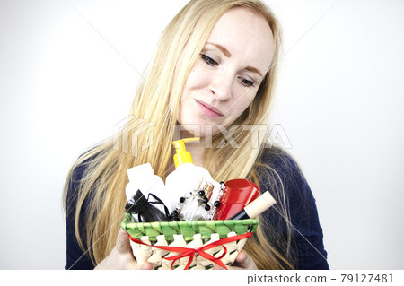 A man gives a beautiful girl a gift - a basket with cosmetics and hygiene products. Pleasant surprise for Birthday, Valentine's Day, March 8 79127481