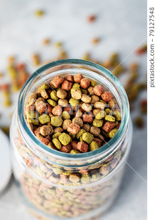 Dry kibble animal food. Dried food for cats or dogs. 79127548