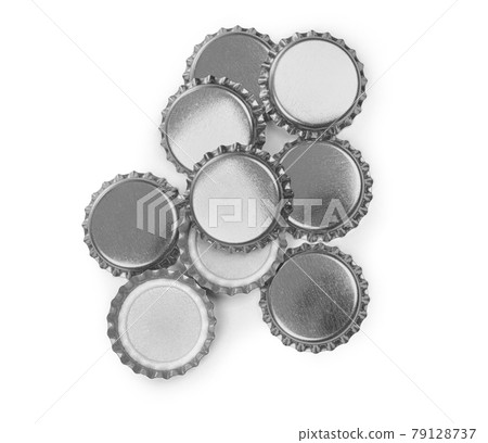 Many beer bottle caps on white background. Many beer bottle caps on white background. 79128737