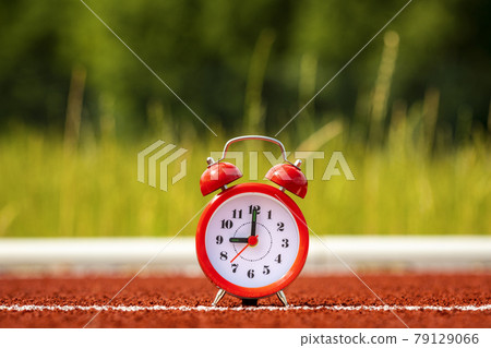 Red alarm clock in the stadium Red alarm clock in the stadium 79129066