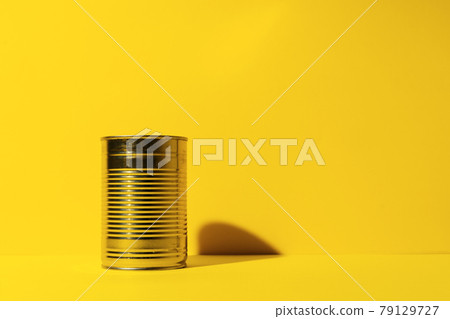 Canned food tin on yellow studio background Canned food tin on yellow studio background 79129727