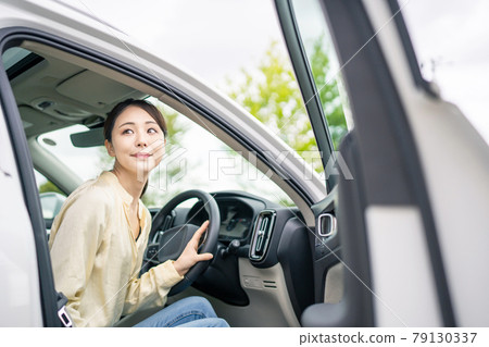 A woman riding a car 79130337