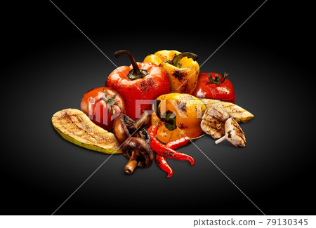 Grilled delicious red and yellow bell pepper, tomatoes, zucchini, champignons, chilli and halves of garlic on black background. Close up 79130345