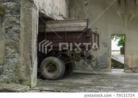 Rusty truck under roof of a dilapidated building in poor tropical country Rusty truck under roof of a dilapidated building in poor tropical country 79131724
