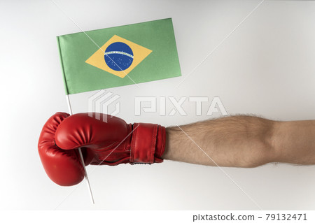 Boxing glove with Brazilian flag. Boxer holds flag of Brazil. White background. 79132471