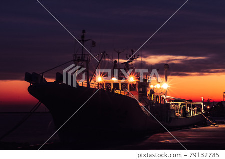 Fishing boat stained in setting sun Fishing boat stained in setting sun 79132785