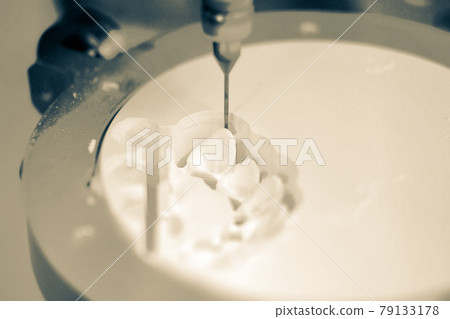 Dental milling machine carving out shape of human teeth 79133178