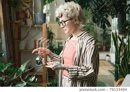 Woman caring about plants Woman caring about plants 79133404
