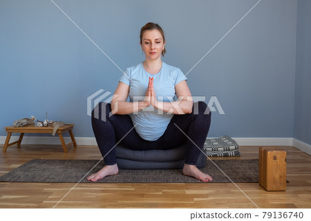 Pregnant yoga woman enjoying yoga practice at home. 79136740