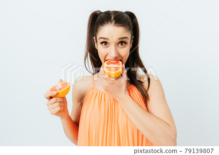 Portrait funny brunette young woman wearing orange top 79139807