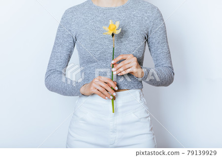 Young woman wearing white high waist jeans and gray crop top long sleeve 79139929