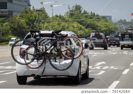 Car carrying a bicycle and driving Car carrying a bicycle and driving 79142084