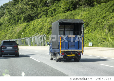 A truck driving on a highway A truck driving on a highway 79142747