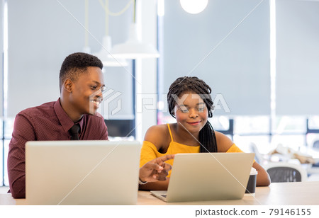 african college university students using laptop together . african college university students using laptop together . 79146155
